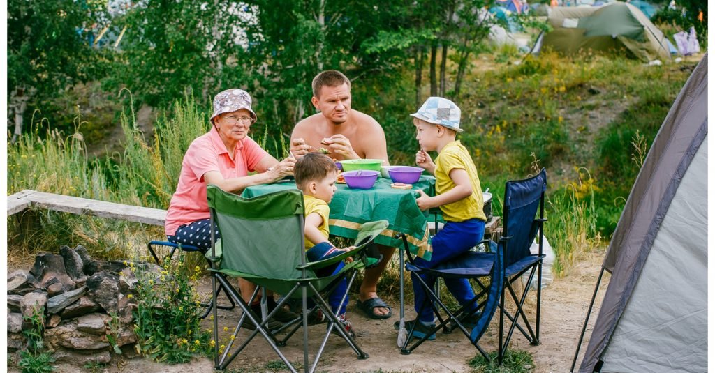 Family Sitting at Folding Table and Chairs