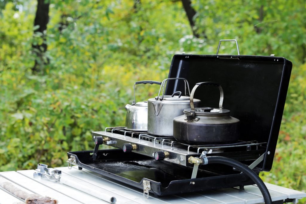 Propane gas camping stove on a folding camping table