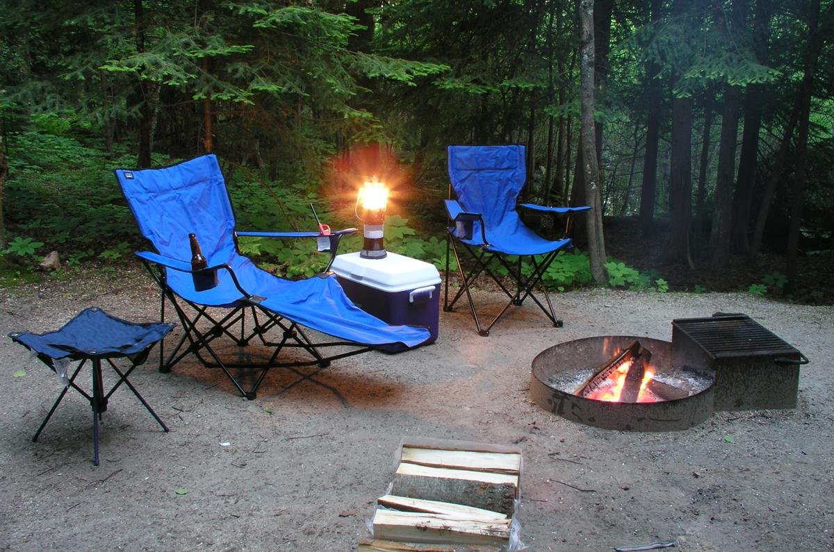 Range of camping chairs: stool, recliner and chair, in a front country campsite