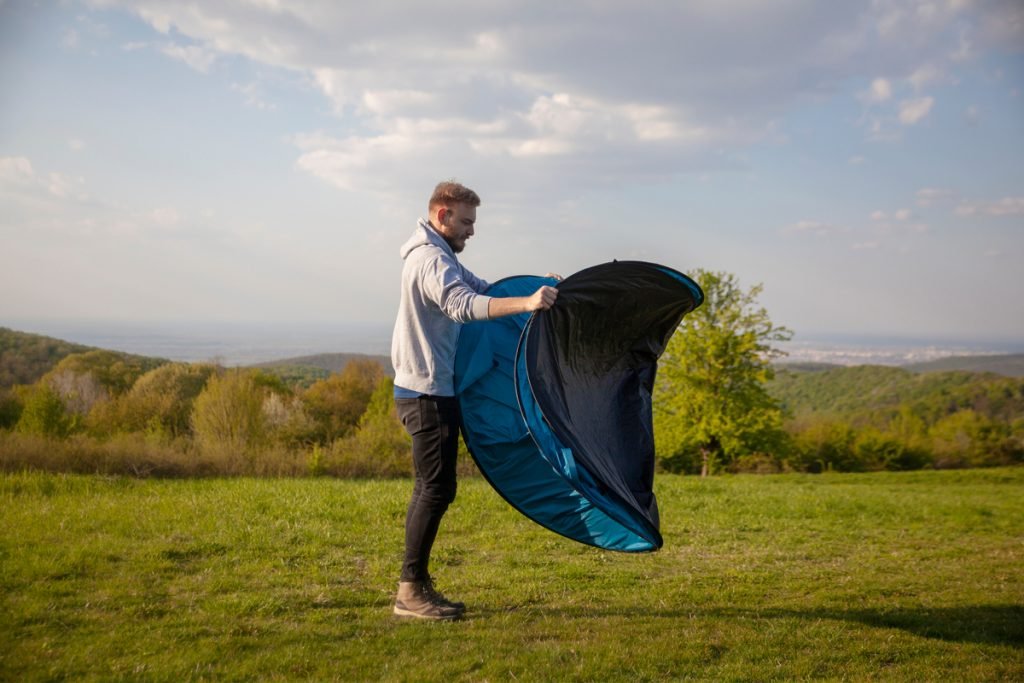 Man releasing a pop up tent