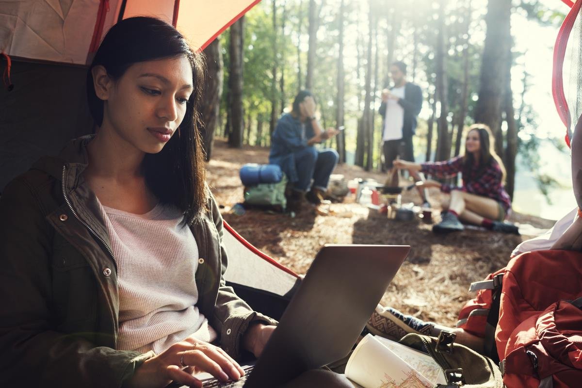 Women in tent working on her laptop