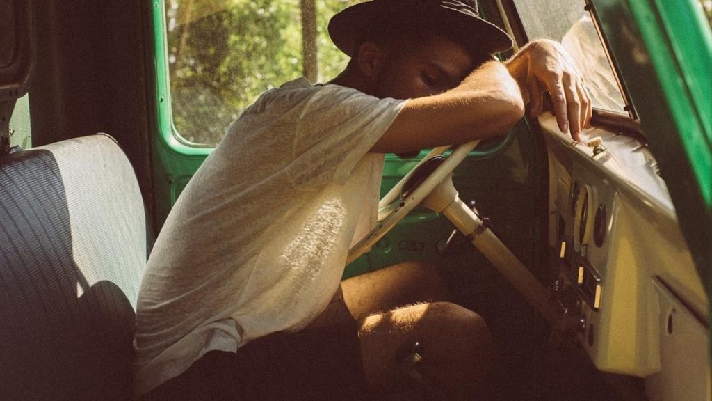 Young man sleeping in car - in-car camping