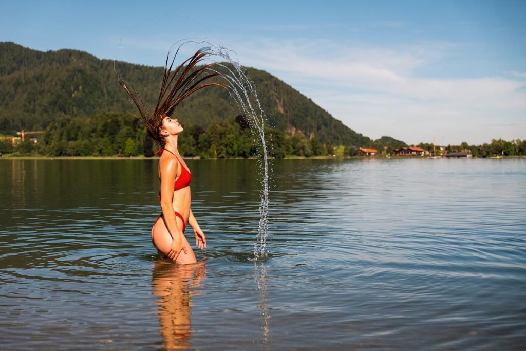 Long haired girl in lake.  This is her solution to how do I dry my hair while camping